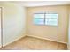 A modest bedroom with carpet flooring, a window for natural light, and a closet at 5096 The Oaks Cir, Orlando, FL 32809