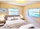 Well decorated bedroom featuring a queen bed, two windows, and modern decor at 5096 The Oaks Cir, Orlando, FL 32809