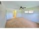 Bright bedroom featuring neutral carpeting, ceiling fan, and natural light from the window at 5096 The Oaks Cir, Orlando, FL 32809