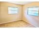 This cozy bedroom features neutral walls and flooring and windows with lush tree views at 5096 The Oaks Cir, Orlando, FL 32809