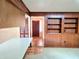 View of the front door, terra cotta tiles, and wood paneled walls from the kitchen at 5096 The Oaks Cir, Orlando, FL 32809