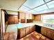 Spacious kitchen featuring tile floors, wood cabinets, and a bright paneled ceiling at 5096 The Oaks Cir, Orlando, FL 32809