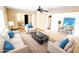 Virtually staged living room with stylish furniture and views into dining area and outdoor pool at 5096 The Oaks Cir, Orlando, FL 32809