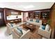 Living room with wood-paneled walls, built-in shelving, and stylish, comfortable furniture at 5096 The Oaks Cir, Orlando, FL 32809