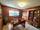 The office space includes wood paneling, built-in shelving, and a comfortable executive chair at 5096 The Oaks Cir, Orlando, FL 32809