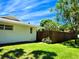 Home's side yard features well-maintained lawn, privacy fence, and lush landscaping, perfect for outdoor enjoyment at 5096 The Oaks Cir, Orlando, FL 32809