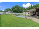 Beautiful backyard features a manicured lawn, storage shed, and sparkling in-ground pool at 51 Seminole Dr, Debary, FL 32713