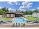 Beautiful backyard with in-ground pool, tanning chairs, manicured lawn, and privacy fence at 51 Seminole Dr, Debary, FL 32713