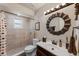 Well-lit bathroom with a large mirror, vanity with sink, toilet, and walk-in shower at 51 Seminole Dr, Debary, FL 32713