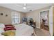 Comfortable bedroom with a ceiling fan, window, carpet, and a computer desk and monitors at 51 Seminole Dr, Debary, FL 32713