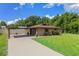 Lovely brick home featuring a carport, a well-maintained lawn, and tasteful landscaping elements at 51 Seminole Dr, Debary, FL 32713