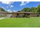 Beautiful brick home with a spacious front lawn, mature trees, and a convenient covered parking area at 51 Seminole Dr, Debary, FL 32713