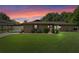 Charming brick home featuring a well-manicured lawn, covered carport, and inviting front garden at 51 Seminole Dr, Debary, FL 32713