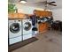Garage featuring a full-size washer and dryer, storage cabinets, and a ceiling fan at 51 Seminole Dr, Debary, FL 32713