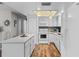 Bright kitchen featuring white cabinetry, stainless appliances, an island, and stylish light fixtures at 51 Seminole Dr, Debary, FL 32713