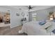 Bright main bedroom with a ceiling fan, carpet floors, and view into a sitting room at 51 Seminole Dr, Debary, FL 32713
