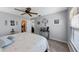 Light-filled bedroom featuring ceiling fan, carpet, and access to a walk-in closet and sitting room at 51 Seminole Dr, Debary, FL 32713