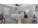 Cozy main bedroom featuring a ceiling fan, bedside tables with lamps, and a window with blinds at 51 Seminole Dr, Debary, FL 32713