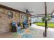 Covered patio with comfortable seating, ceiling fan, and view of the landscaped backyard at 51 Seminole Dr, Debary, FL 32713