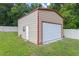 Tan-colored storage shed with red trim is adjacent to manicured lawn and privacy fence at 51 Seminole Dr, Debary, FL 32713