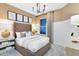 This bedroom features an upholstered headboard, soft neutral decor and an abundance of natural light from the large window at 5174 Gardenrow Dr, St Cloud, FL 34772