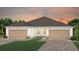 Beautiful home exterior with a two-car garage and well-manicured lawn, perfect for suburban living at 5174 Gardenrow Dr, St Cloud, FL 34772
