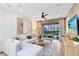 A bright living room has a large sectional sofa, modern art, and sliding glass doors to the pool area at 5174 Gardenrow Dr, St Cloud, FL 34772