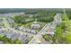 Community aerial view showcasing the pool, playground, neighborhood streets, and lush green landscaping at 522 Anne St, Deland, FL 32724