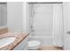 Clean bathroom featuring a granite vanity, shower/tub, and white toilet at 522 Anne St, Deland, FL 32724