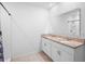 Bathroom featuring double sink vanity with granite countertop and a walk-in shower at 522 Anne St, Deland, FL 32724