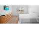 Bright bedroom with plush carpet, a large window, and a dresser for ample storage at 522 Anne St, Deland, FL 32724