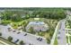 Aerial view of the community pool, playground, parking and recreation areas surrounded by trees at 522 Anne St, Deland, FL 32724