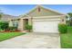 Close up of the front exterior highlighting the manicured landscaping at 522 Anne St, Deland, FL 32724