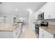 Modern kitchen featuring white cabinets and stainless steel appliances at 522 Anne St, Deland, FL 32724