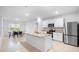Bright kitchen featuring an island with granite countertops, stainless steel appliances, and an adjacent dining area at 522 Anne St, Deland, FL 32724