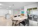 Open-concept living space connecting the kitchen, dining area, living room, and outdoor patio for seamless indoor-outdoor living at 522 Anne St, Deland, FL 32724