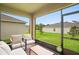 Screened patio featuring outdoor furniture and a view of the green backyard at 522 Anne St, Deland, FL 32724