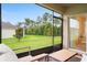 Screened patio features outdoor furniture and view of trees in the backyard at 522 Anne St, Deland, FL 32724