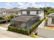 Aerial view of a two-story home with an enclosed pool and manicured landscaping at 7454 Gathering Dr, Reunion, FL 34747