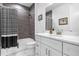 Elegant bathroom with a marble countertop vanity and stylish shower-tub featuring monochrome accents at 7454 Gathering Dr, Reunion, FL 34747