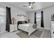 Bright bedroom with white furnishings, ceiling fan, and natural light from large windows at 7454 Gathering Dr, Reunion, FL 34747