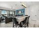 Dining area adjacent to the Gathering room with outdoor views, modern lighting, and comfortable seating at 7454 Gathering Dr, Reunion, FL 34747