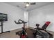 Spacious exercise room featuring modern workout equipment, TV, and ceiling fan at 7454 Gathering Dr, Reunion, FL 34747