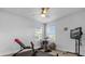 Home gym area with stationary bike, weight bench, and mounted television for workouts at 7454 Gathering Dr, Reunion, FL 34747