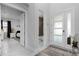 Bright foyer with modern front door, tile flooring, and views into the bedroom and bathroom at 7454 Gathering Dr, Reunion, FL 34747