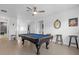 Open game room featuring a pool table, ceiling fan, and views of multiple hallways at 7454 Gathering Dr, Reunion, FL 34747