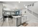 Open-concept kitchen with an island bar overlooking the Gathering room and backyard at 7454 Gathering Dr, Reunion, FL 34747