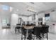 Bright kitchen with white cabinets, stainless steel appliances, kitchen island, and adjacent dining area at 7454 Gathering Dr, Reunion, FL 34747