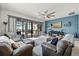 Cozy Gathering room with sliding doors to the outside, comfortable seating, and modern decor at 7454 Gathering Dr, Reunion, FL 34747