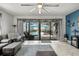 Gathering room with sliding doors to the pool and outdoor area, ample lighting, and comfortable seating at 7454 Gathering Dr, Reunion, FL 34747